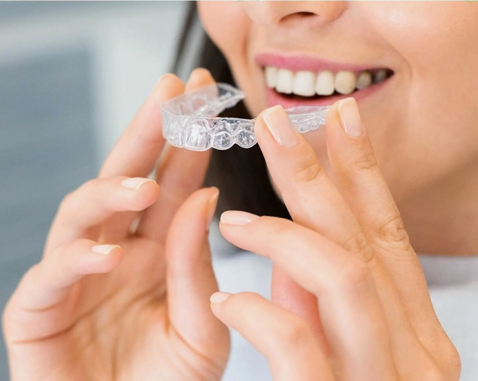 Woman fitting a clear aligner
