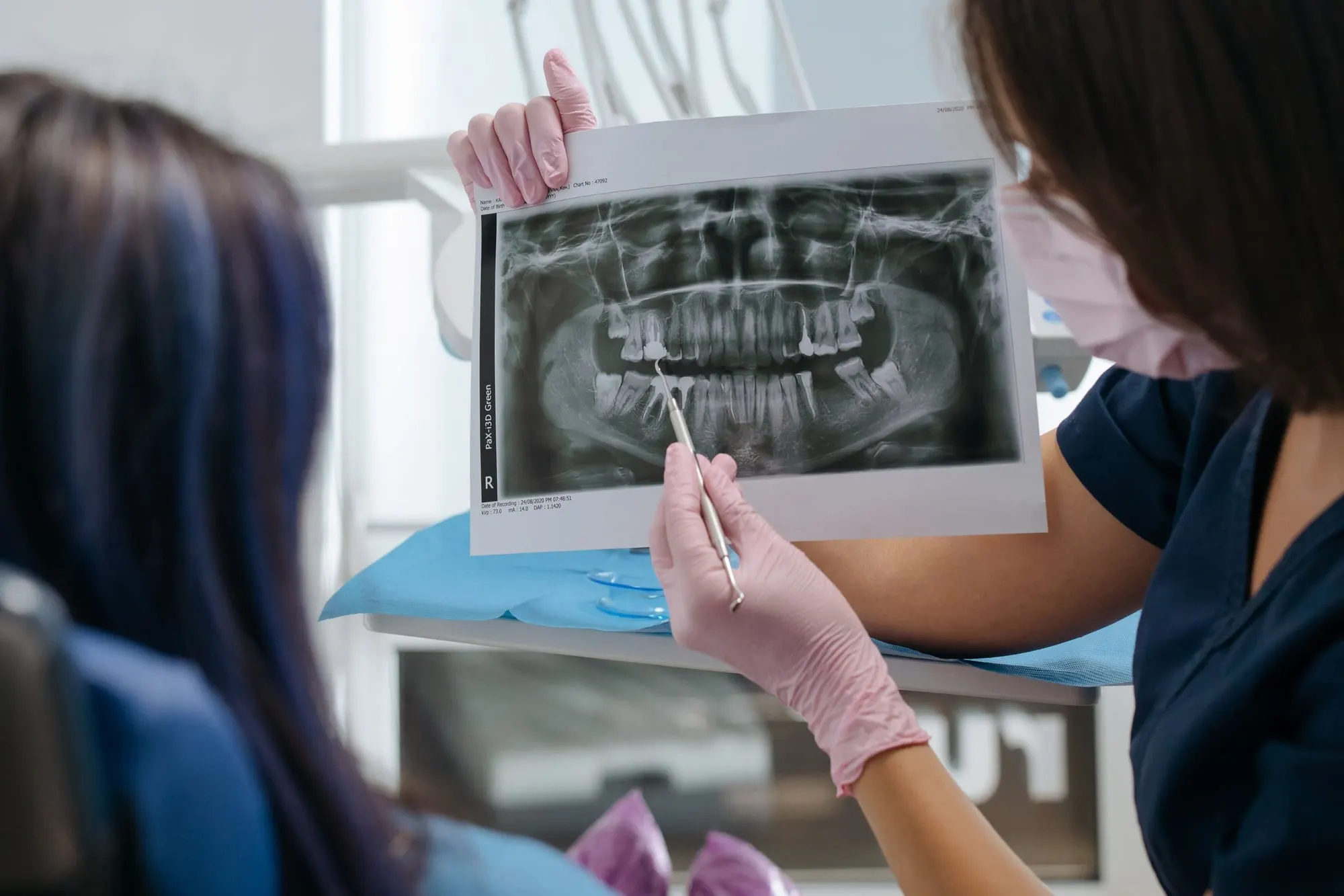 Dentist showing a patient their dental X-ray