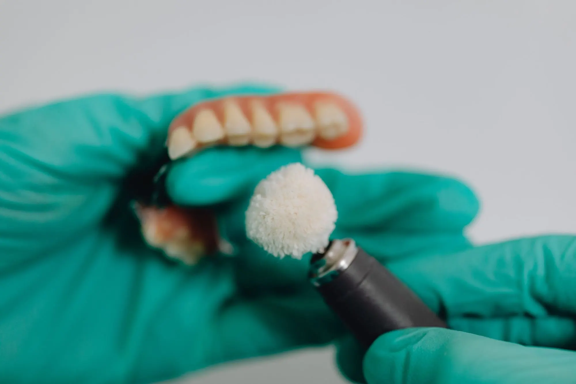 Denture being finished and polished