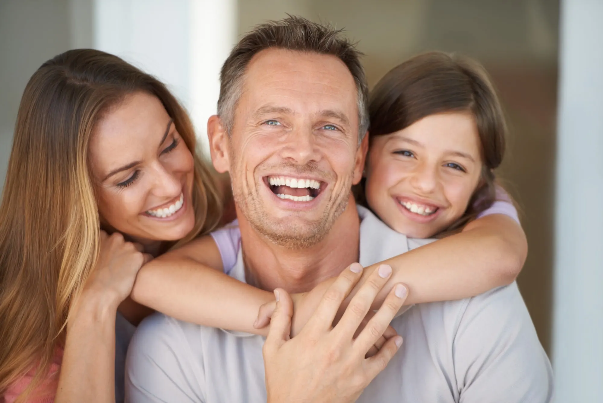 Happy family who look after their smiles with a dental plan