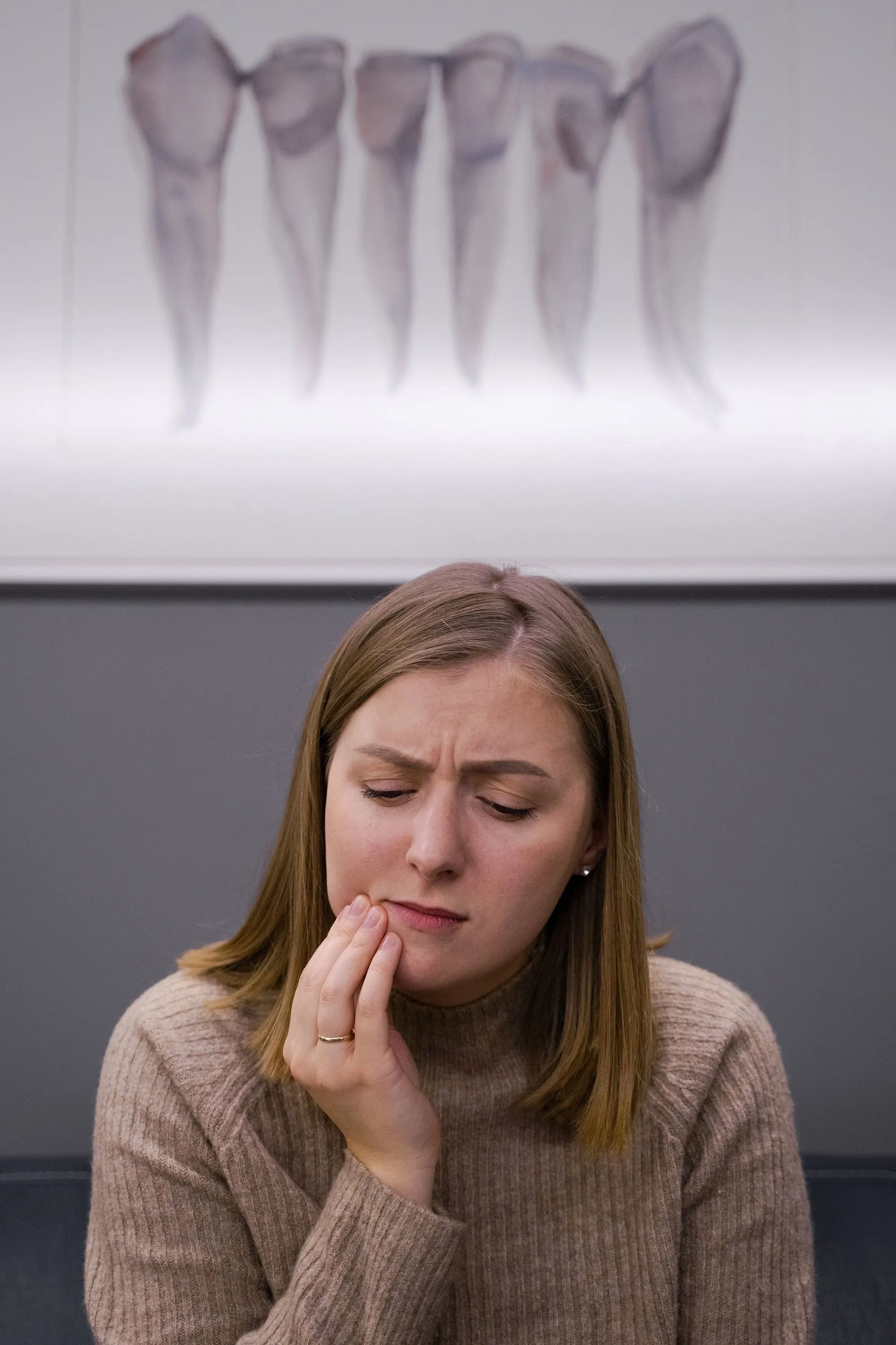 Woman holding her cheek with toothache